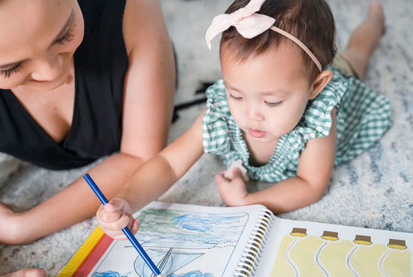 Preschool in Singapore: Mom teaching child coloring