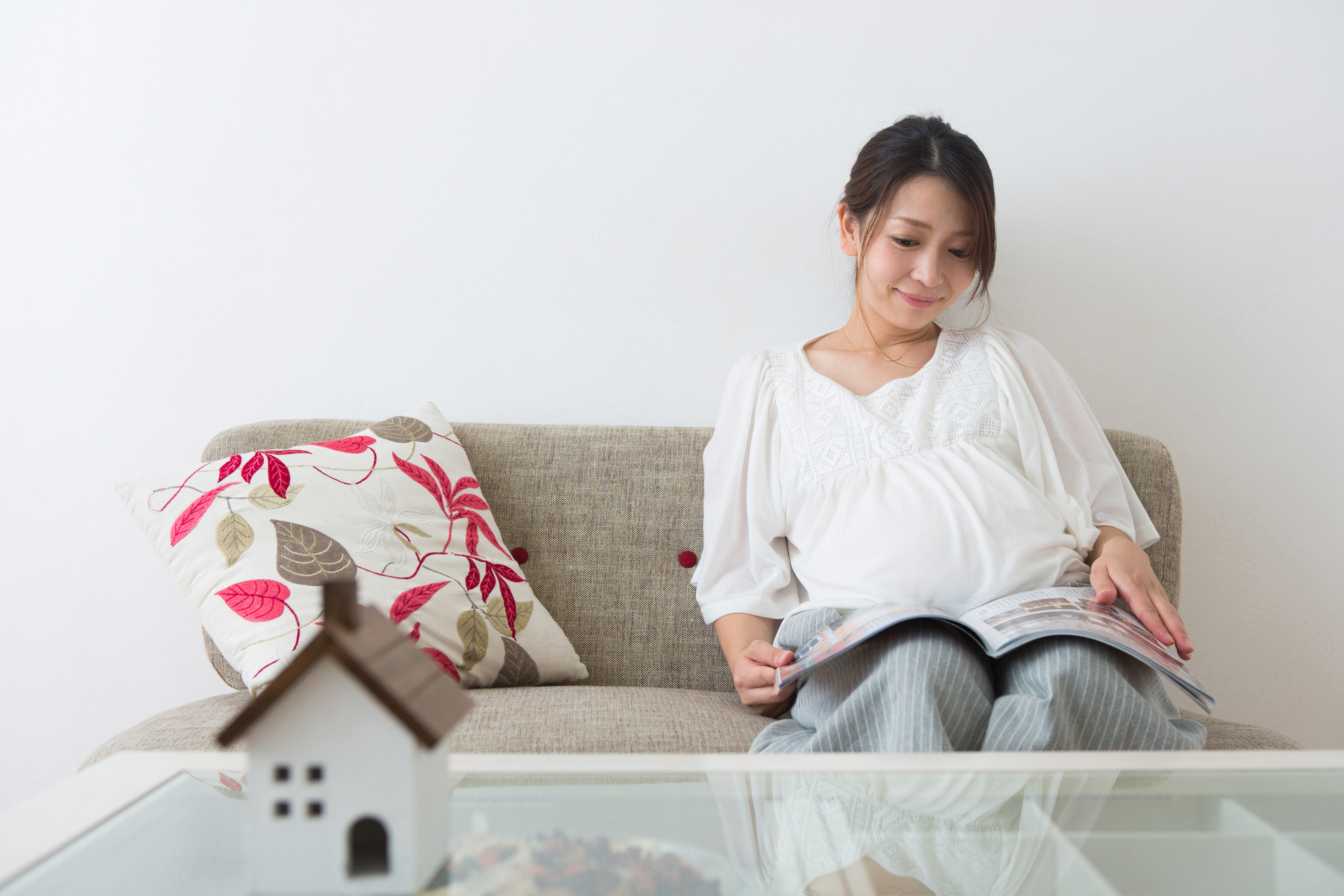 5 weeks pregnant woman sitting on a couch reading a book