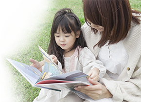 toddler reading with mum